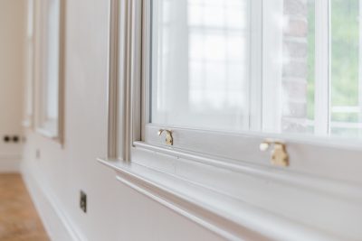 White trim installation to highlight the frame of a new window.